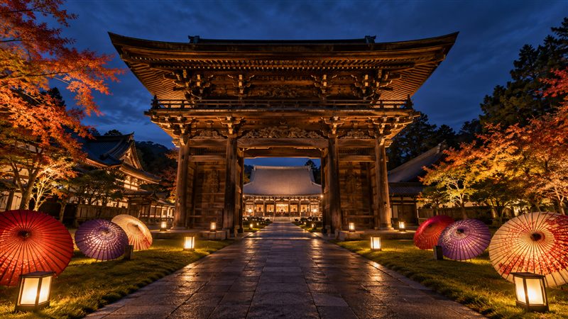 夜にライトアップされた瑞龍寺の山門と和傘